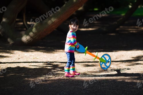 Preview: Young Girl Playing Outdoor Measure-Mate In The Forest Park For Leaning Measurement