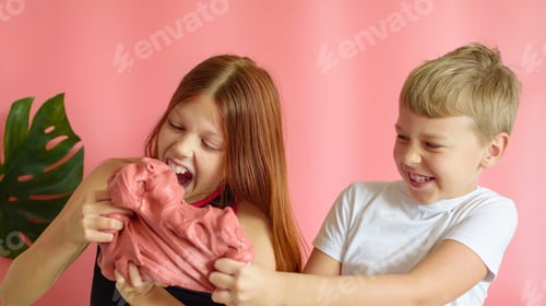 Preview: Cute Blonde Boy And Red Hair Girl Playing With Hand Made Slime And Having Fun On Pink Background