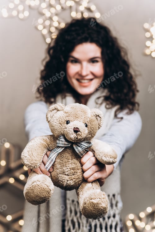 Preview: Cute Girl Holds A Teddy Bear In Her Hands. Christmas And New Year Concept
