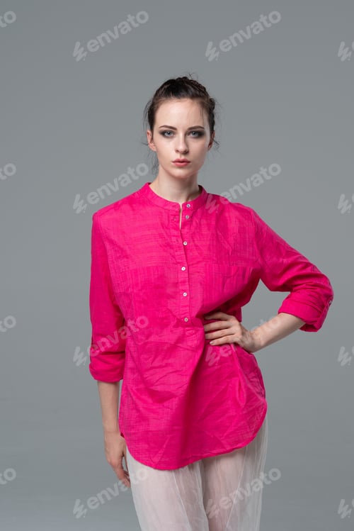 Preview: Young Beautiful Girl Posing In The Studio Is In The Red Shirt