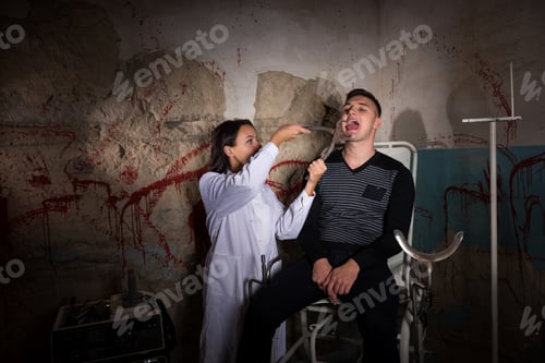 Preview: Female Scientist Holding Medical Forceps In Front Of Patient And Tries To Cut Off The Tongue In
