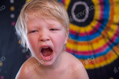 Preview: Happy Cute Caucasian Boy Changed Clothes At Carnival In Dress Of Girl Of Rainbow Color. Blond Hair