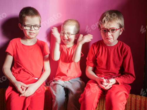 Preview: Funny Children In Red Clothes Posing In Front Of Camera. Boys Actively Express Their Emotions