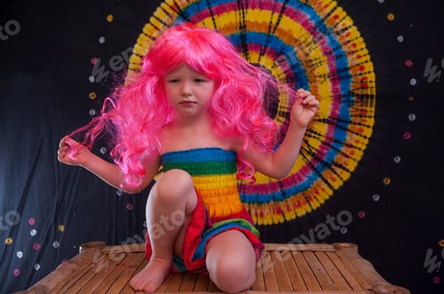 Preview: Happy Cute Caucasian Boy Changed Clothes At Carnival In Dress Of Girl Of Rainbow Color. Pink Doll