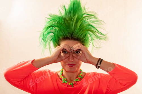 Preview: Funny Caucasian Girl In A Green Dress And With Green Hair And Sunglasses Is Preparing For The