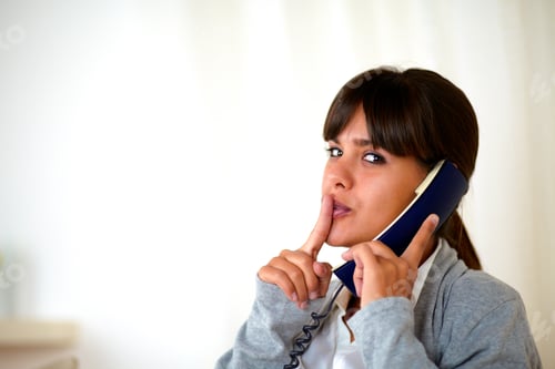 Preview: Portrait Of A Young Woman Requesting Silence While Speaking On Phone - Copyspace