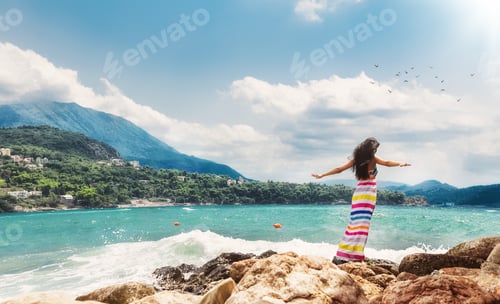 Preview: Relaxed Woman With Open Arms From Behind On Sea. Girl From Behind View Enjoying In A Summer Day