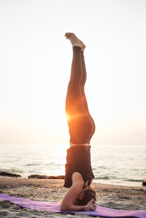 Preview: Young Caucasian Female Practicing Yoga On The Seaside During The Sunrise
