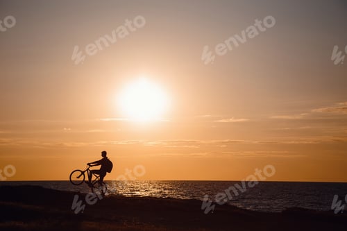 Preview: Silhouette Of Cyclist In Motion At Beautiful Sunset. The Idea And Concept Of A Healthy Lifestyle