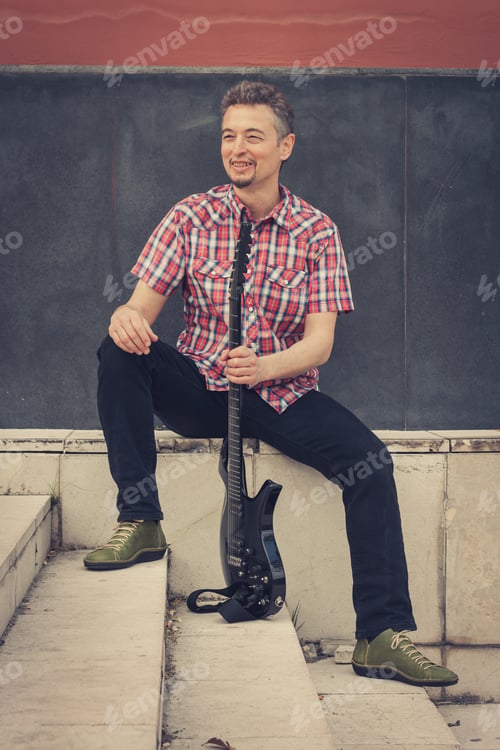 Preview: Man In Short Sleeve Shirt Playing Electric Guitar In The Street