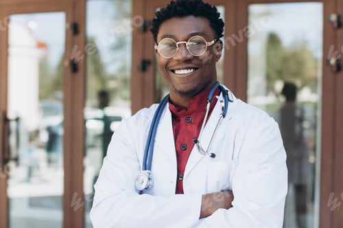 Preview: Handsome African Male Doctor Outside Of Hospital Building.