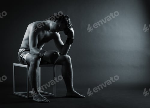 Preview: Upset Boxer Sitting Head In Hands.