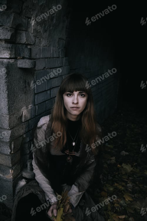 Preview: Shot Of A Gothic Woman In Autumn Near Brick Wall