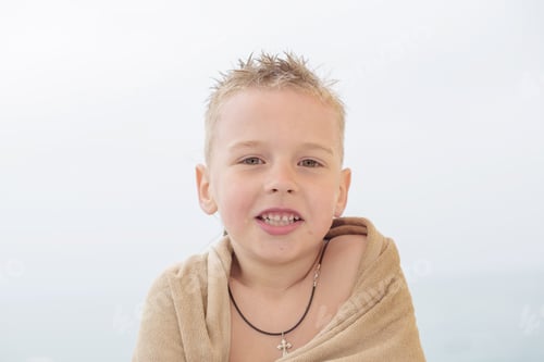Preview: Blond Boy In Towel On The Beach
