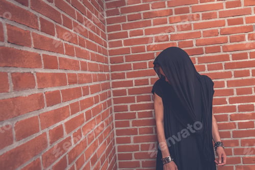 Preview: Young Handsome Asian Model Dressed In Black Tunic Posing With A Brick Wall In Background