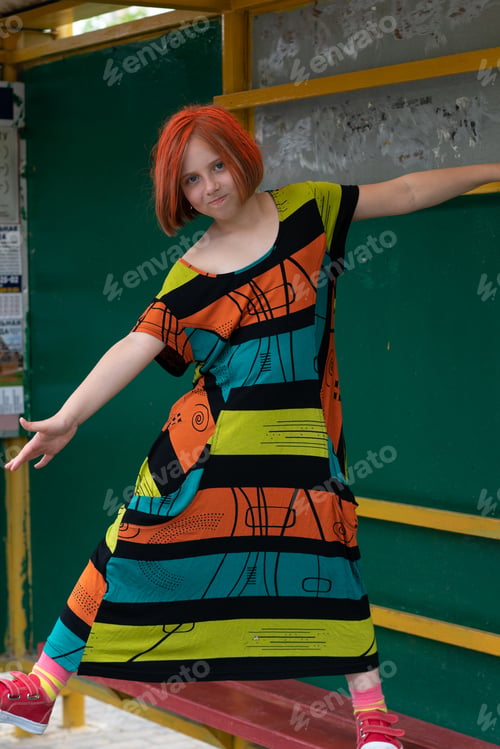 Preview: Small Girl Outside In The City Is In A Colored Dress