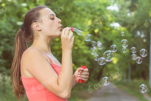 Preview: Young Woman Blowing Bubbles Outdoor. Caucasian Female Relaxing Lifestyle In The Park.