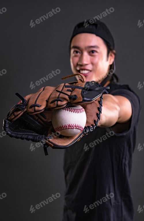 Preview: Asian Professional Baseball Player In Action. Isolated On Black Background.