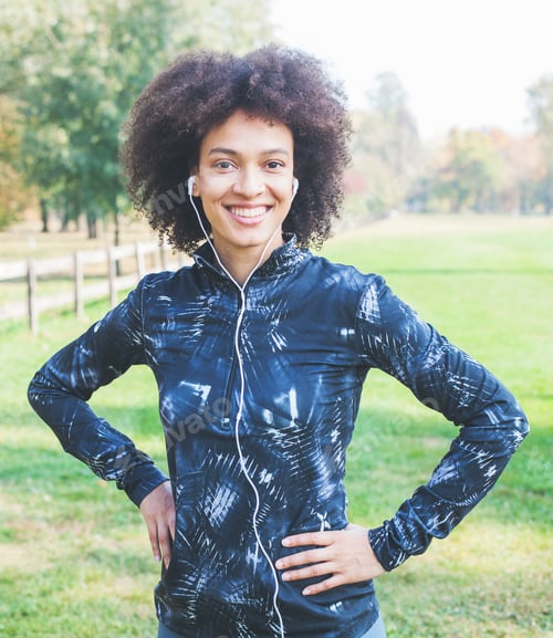 Preview: Portrait Of Afro Fitness Happy Woman Listening Music After Exercise In Nature And Ready For