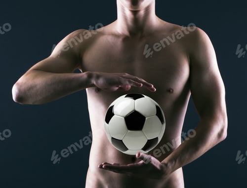 Preview: Soccer Player With A Soccer Ball In His Hands On A Dark Background.