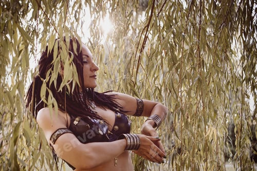Preview: Beautiful Woman Dancing Tribal Near The Large Willow Tree
