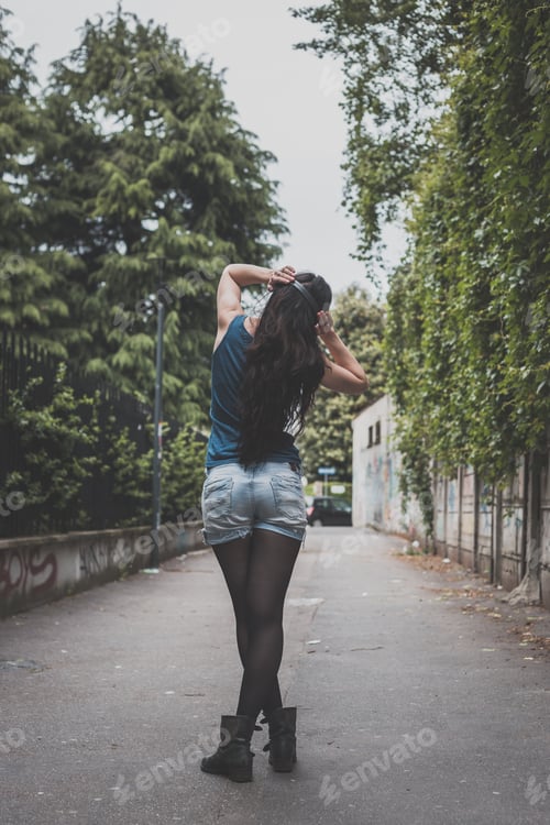 Preview: Beautiful Girl With Long Hair Posing In The City Streets