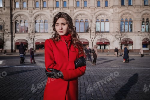 Preview: Happy Women Walking In Red Coat At The Red Square In Moscow. Cold Time Between Winter And Spring