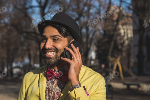 Preview: Portrait Of An Indian Young Handsome Man Talking On Phone In An Urban Context
