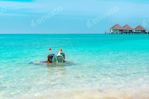 Preview: Children A Boy And A Girl Swim Near The Shore In A Full Face Snorkeling Mask In Maldives