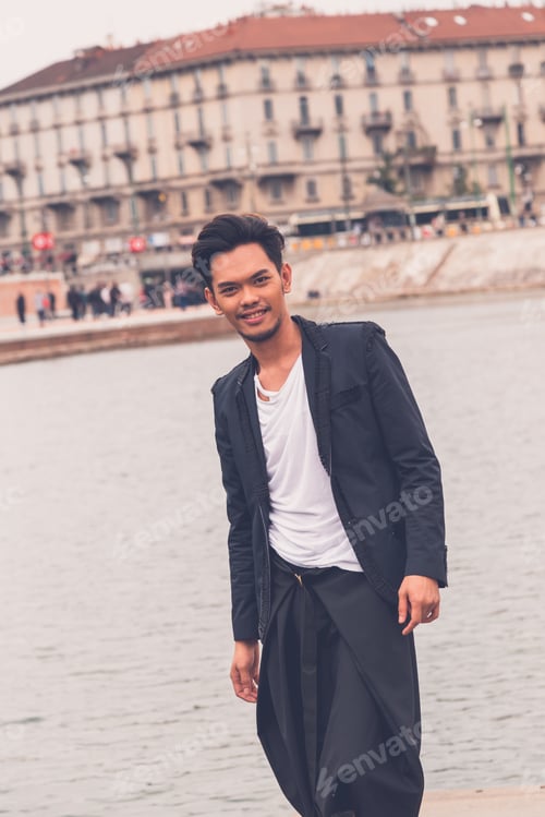 Preview: Young Handsome Asian Model Dressed In Black Posing By An Urban Artificial Basin