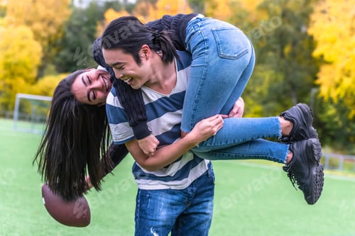 Preview: Couple In Park With American Football. Couple Playing American Football. Couple Playing Rugby