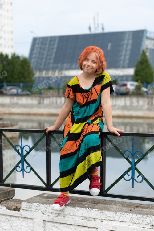 Preview: Little Girl Posing In A City Standing In A Colored Dress