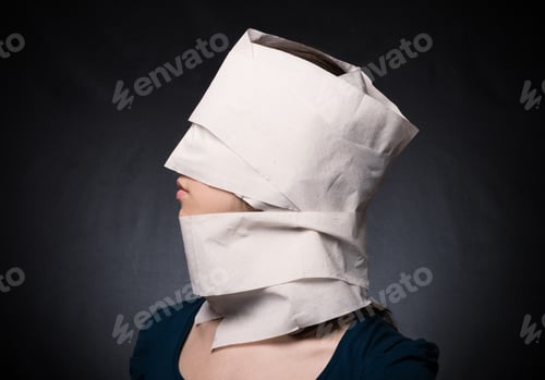 Preview: Young Woman'S Head Wrapped In Paper. Symbol Of Loneliness And Alienation.