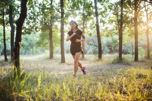 Preview: Young Caucasian Female Running In Park. Female Jogging In Park