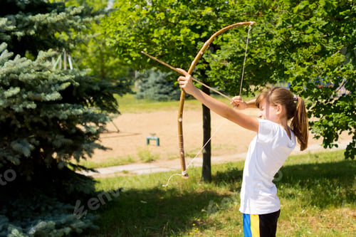 Preview: Girl Practising Outdoors With A Arch And Arrow