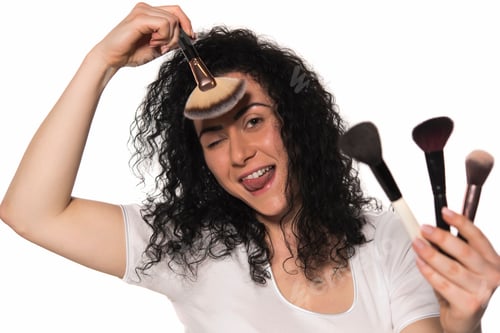Preview: Portrait Of The Beautiful Woman With Make-Up Brushes Near Attractive Face. Adult Girl Posing Over