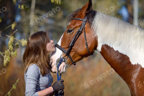 Preview: Girl Sportswoman And Her Horse After A Riding In The Spring
