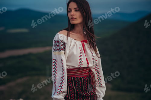 Preview: Attractive Woman In Traditional Romanian Costume On Mountain Green Blurred Background. Outdoor
