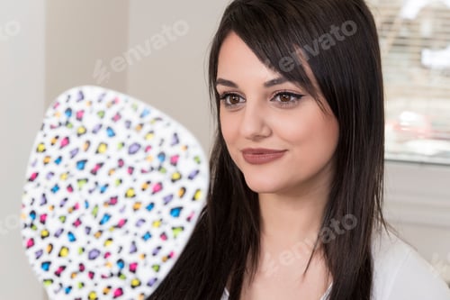 Preview: Close Up Of Beautiful Woman Looking Herself In The Mirror
