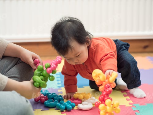 Preview: Asian Baby Playing Toy At Home