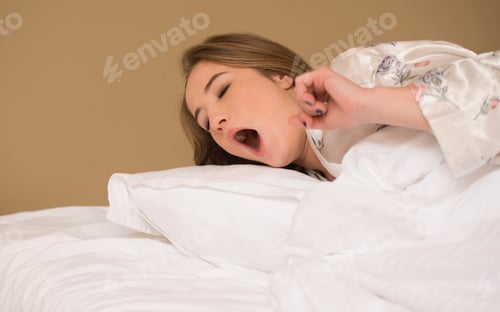 Preview: Young Girl Yawning Lying In Bed Getting Ready For A Dream
