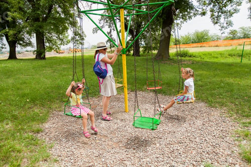 Preview: Mother And Daughters Have Fun In Summer Park At Carousel Swing