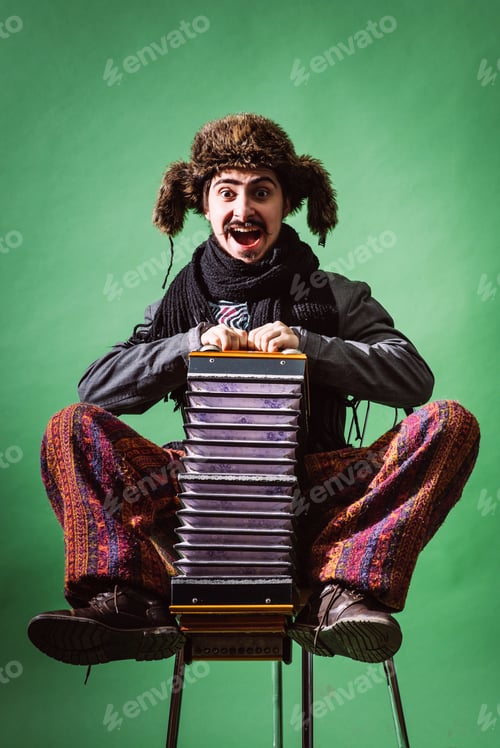 Preview: Positive Man With Accordion Posing In Studio