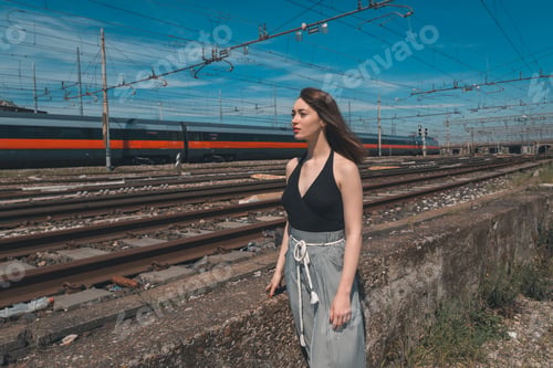 Preview: Beautiful Young Brunette With Long Hair Posing Along Railroad Tracks