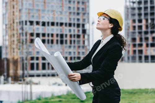Preview: A Portrait Of Engineer Woman Looking Construction. Woman Architect With Blueprint In Hand And