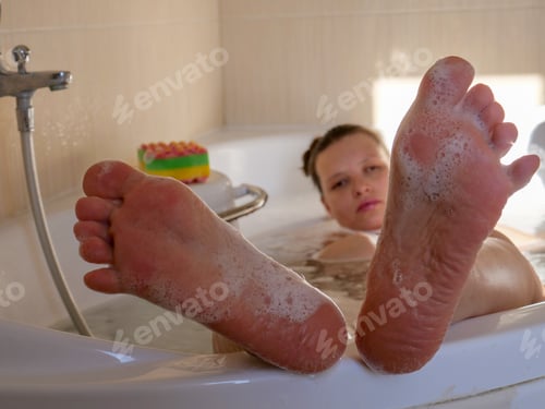 Preview: Beautiful Woman Washes Her Feet With Bath Gel And Rubs Her With Nail Brush