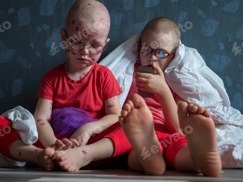 Preview: Caucasian Children In Pink T-Shirt With Smartphone On Floor. Boys Posing For Camera Under White
