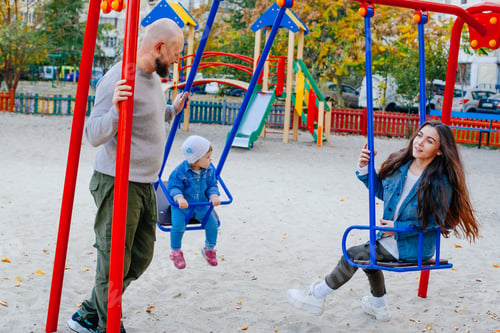 Preview: Happy Family With Little Kid On The Children Ground Playing All Together
