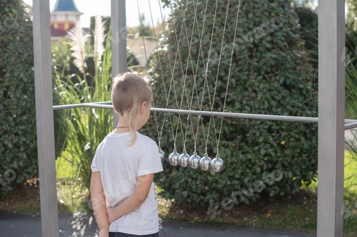 Preview: Little Boy Plays With A Pendulum