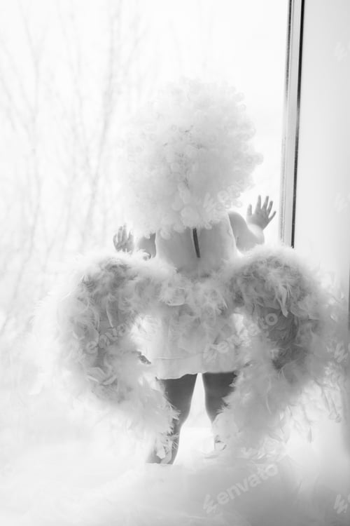Preview: Girl Dressed As An Angel On A Light Background.Little Cupid